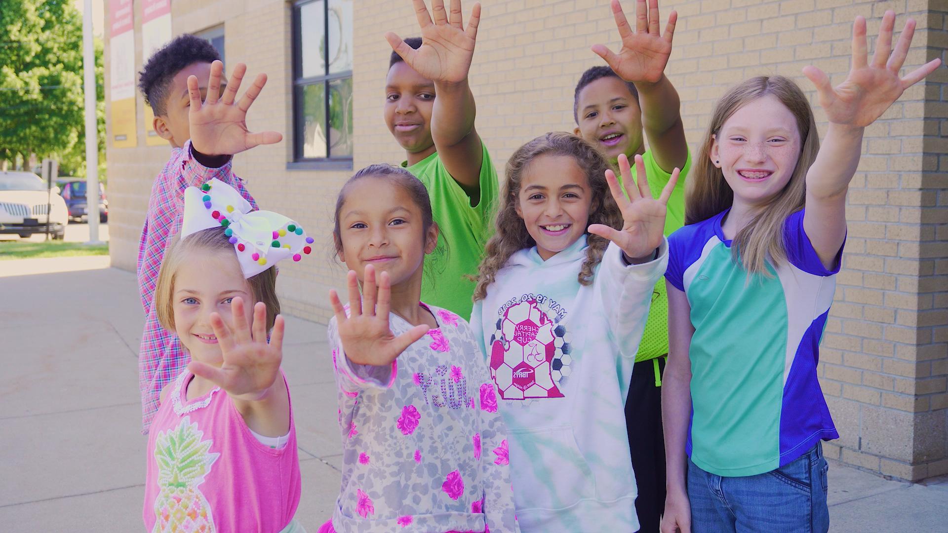 Young students encouraging others to Strive for Less Than 5 days absent